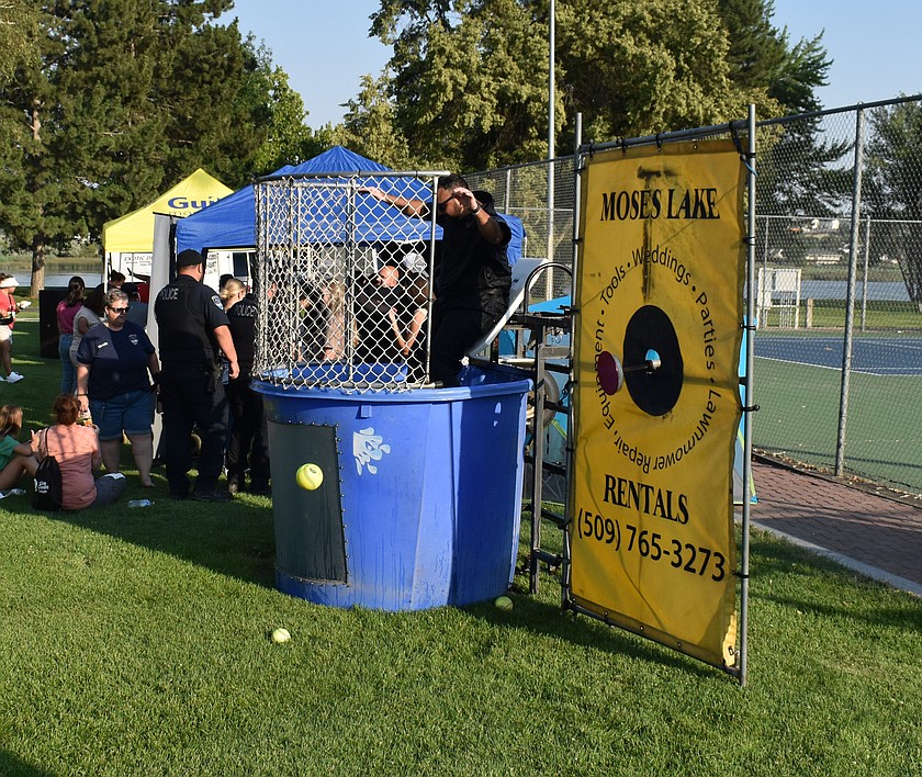 Moses Lake Police Ofc. Jose Ramirez takes a plunge into the dunk tank at a previous National Night Out. The tank will be a fixture at this year’s event as well, which will be held at Sinkiuse Square Aug. 4.