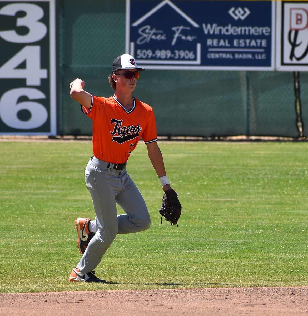 Clayton Wolther from the Tigers Baseball Club gets ahold of the ball and gets ready to throw it back toward the mound.