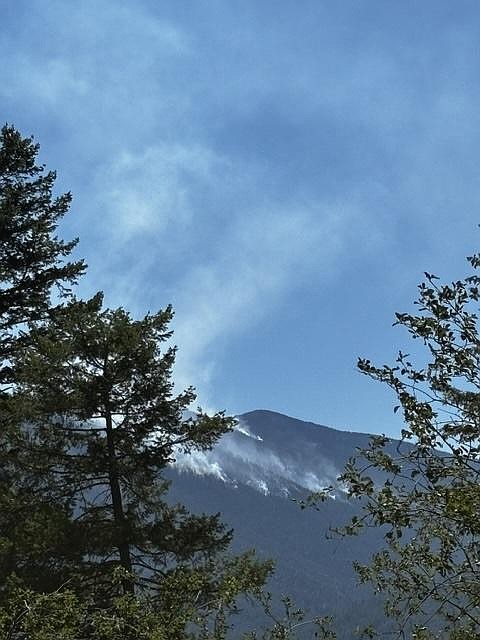 Upper Smith Fire puts up a weak smoke column on Monday, July 13.