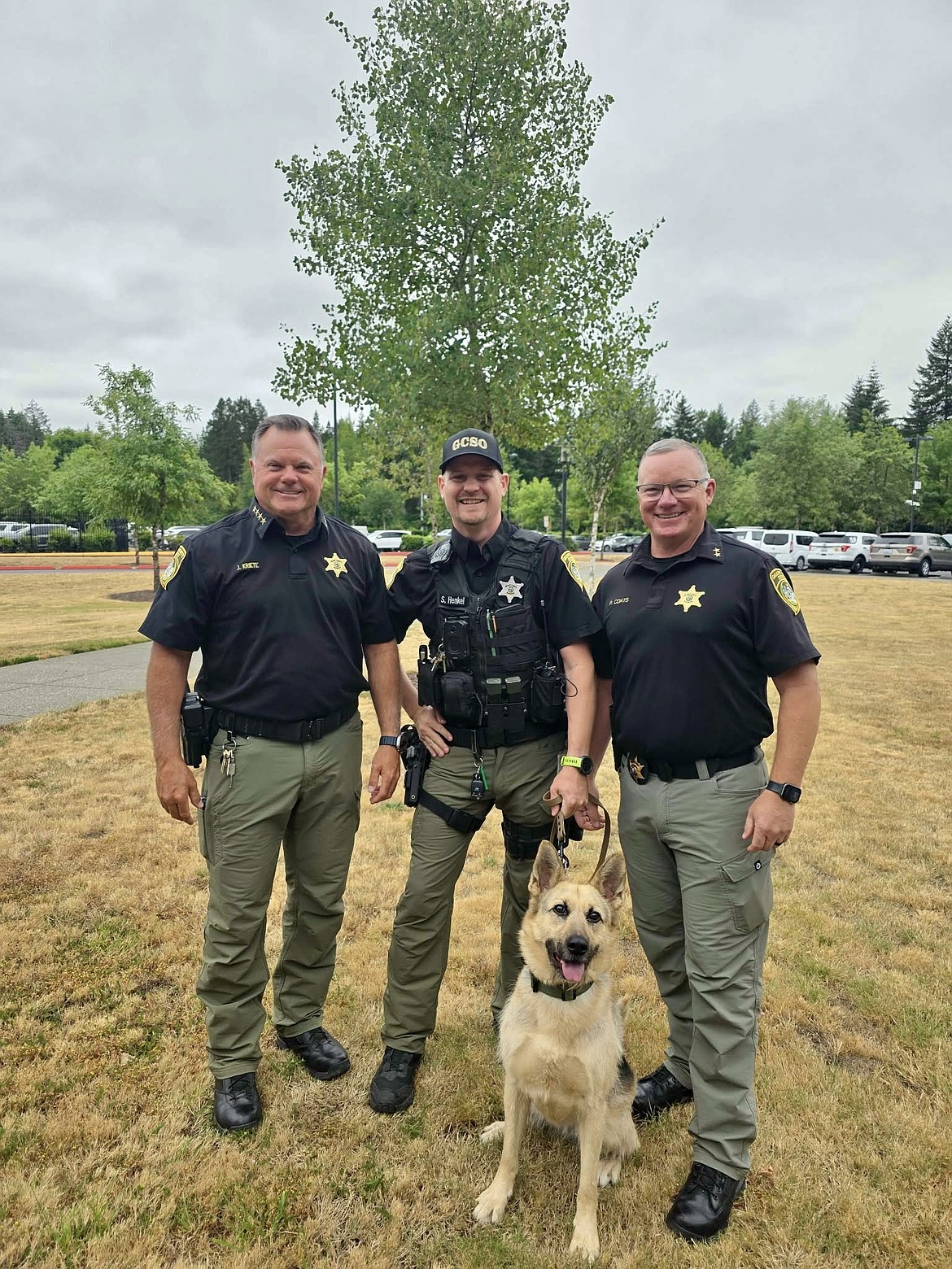 Grant County Sheriff’s Office Sheriff Joey Kreite (left), Deputy Seth Henkel (middle), K-9 Nova and Chief Deputy of Corrections Phillip Coats (right) smile for a photo. Nova is the newest K9 at GCSO and is trained to detect black tar heroin, cocaine, methamphetamine and fentanyl.
