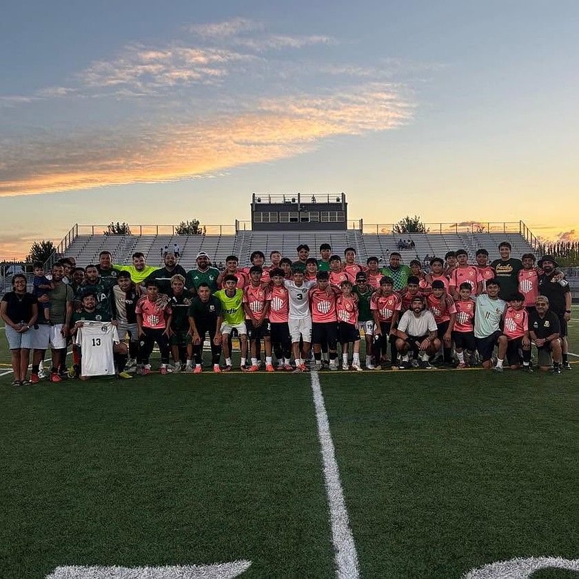 Jacks alumni and current high school players gather for a group photo during the alumni game in Quincy July 10.