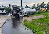 Commercial truck spills 4,000 gallons of asphalt seal coat in Evergreen