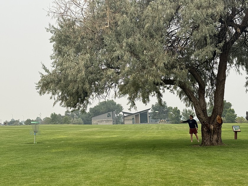 A frisbee golfer at Lower Peninsula Park enjoys an afternoon on the course all to himself.