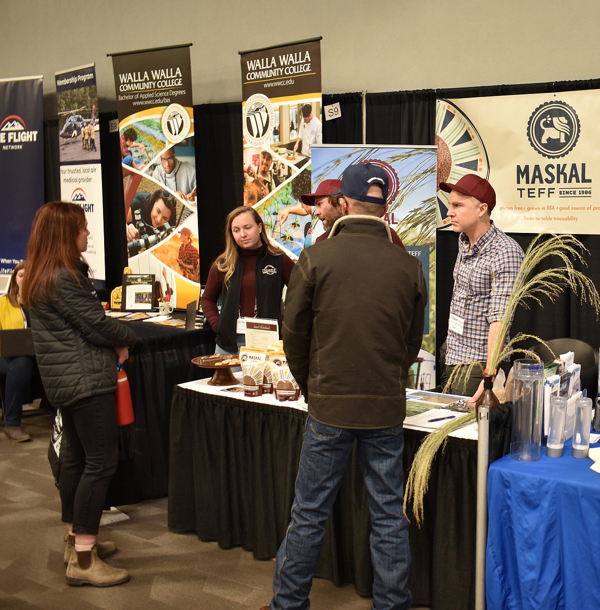 Maskal Teff representatives talk with visitors at the Spokane Ag Show. Trade shows are an opportunity for producers like Maskal Teff to get new products in front of both industry professionals and consumers.