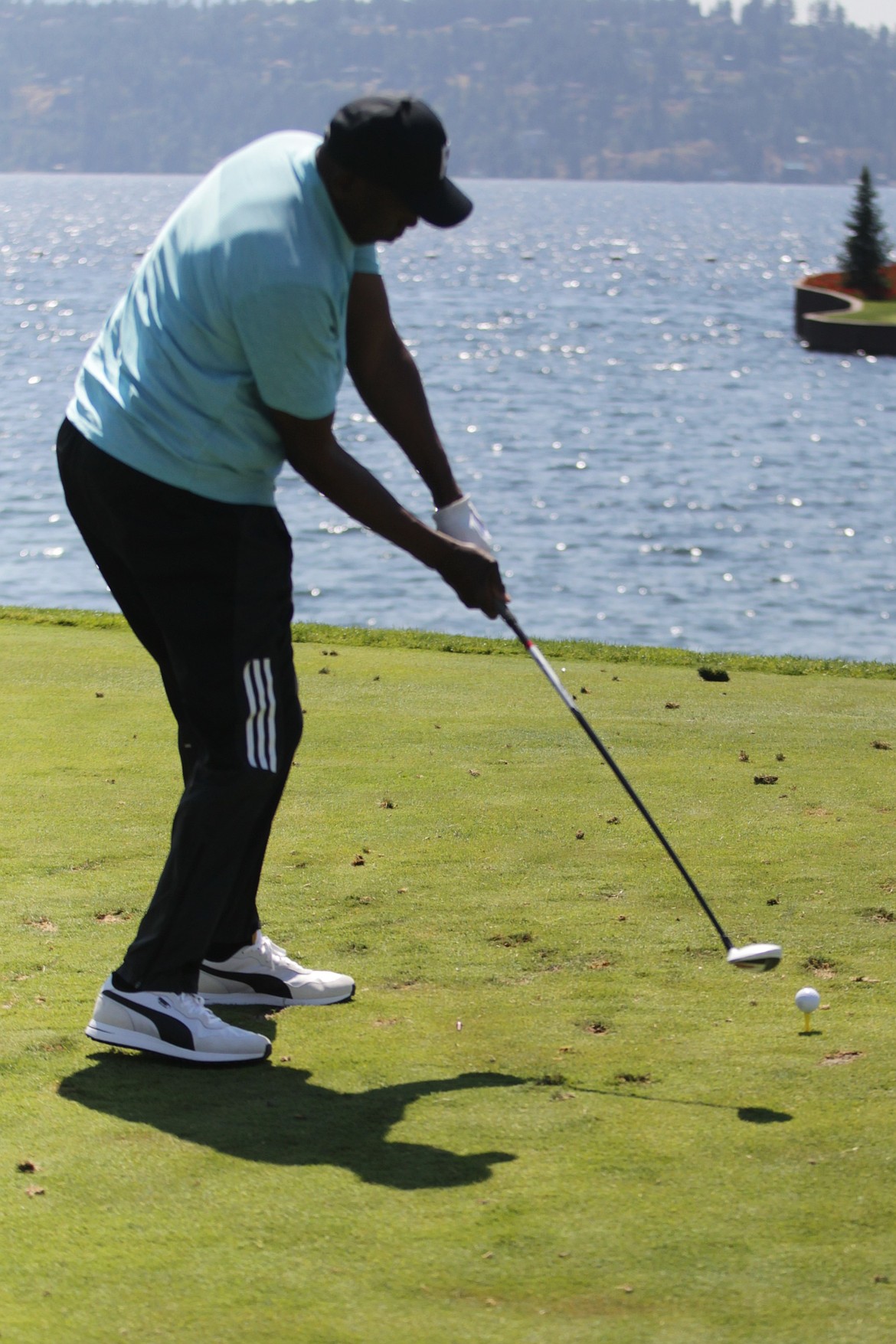 JASON ELLIOTT/Press
Al Joyner, who won a gold medal in the 1984 Summer Olympics in Los Angeles, tees off toward The Floating Green during The Showcase golf tournament at The Coeur d'Alene Resort on Friday.