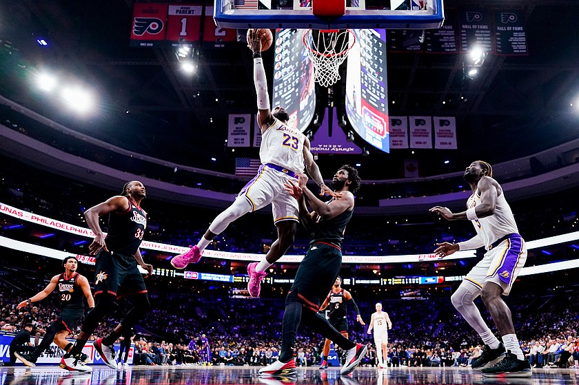 FILE - Los Angeles Lakers' LeBron James, center left, goes up for the shot against Philadelphia 76ers' Joel Embiid, center right, during the second half of an NBA basketball game, Dec. 7, 2025, in Philadelphia.