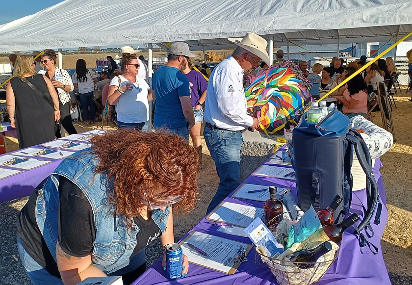 Bidders make their mark at the Man Up Crusade’s silent auction, hosted by the Moses Lake Roundup and the Moses Lake Chamber of Commerce. This year’s auction is Aug. 11.