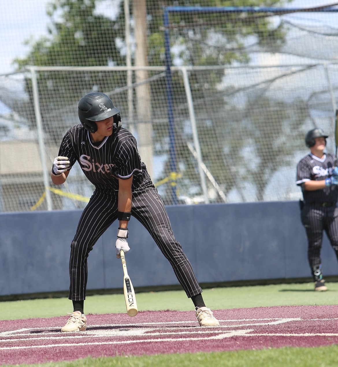 Nolan Decubber (12) taps home plate ahead of his next swing while at bat for the Sixers earlier this season.