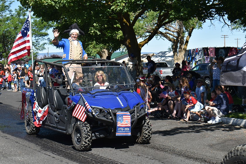 George Washington, played by Joseph Brent Adams of Ephrata, waves to the crowd in the Independence Day parade in George.