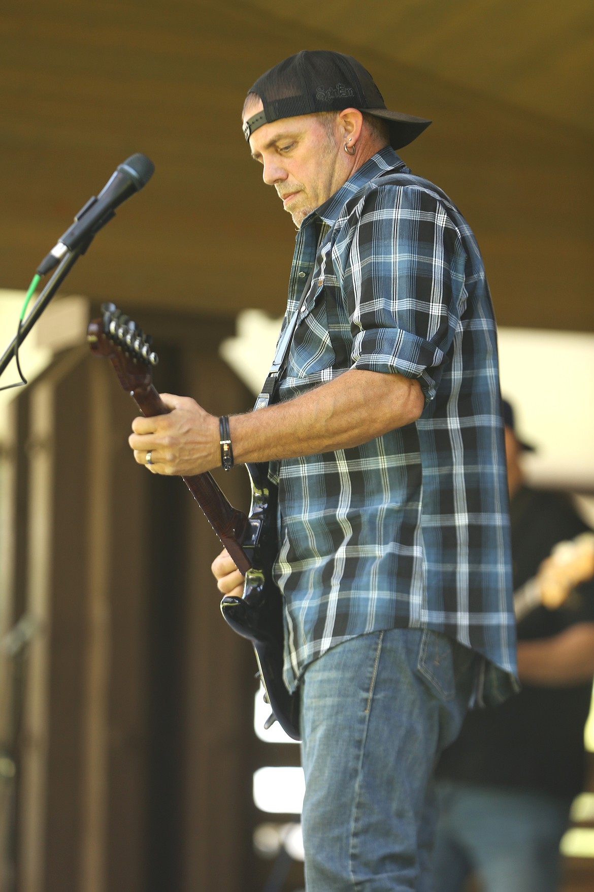 Nate Ostrander performs with band Karma's Circle at the City Park bandshell on Friday.