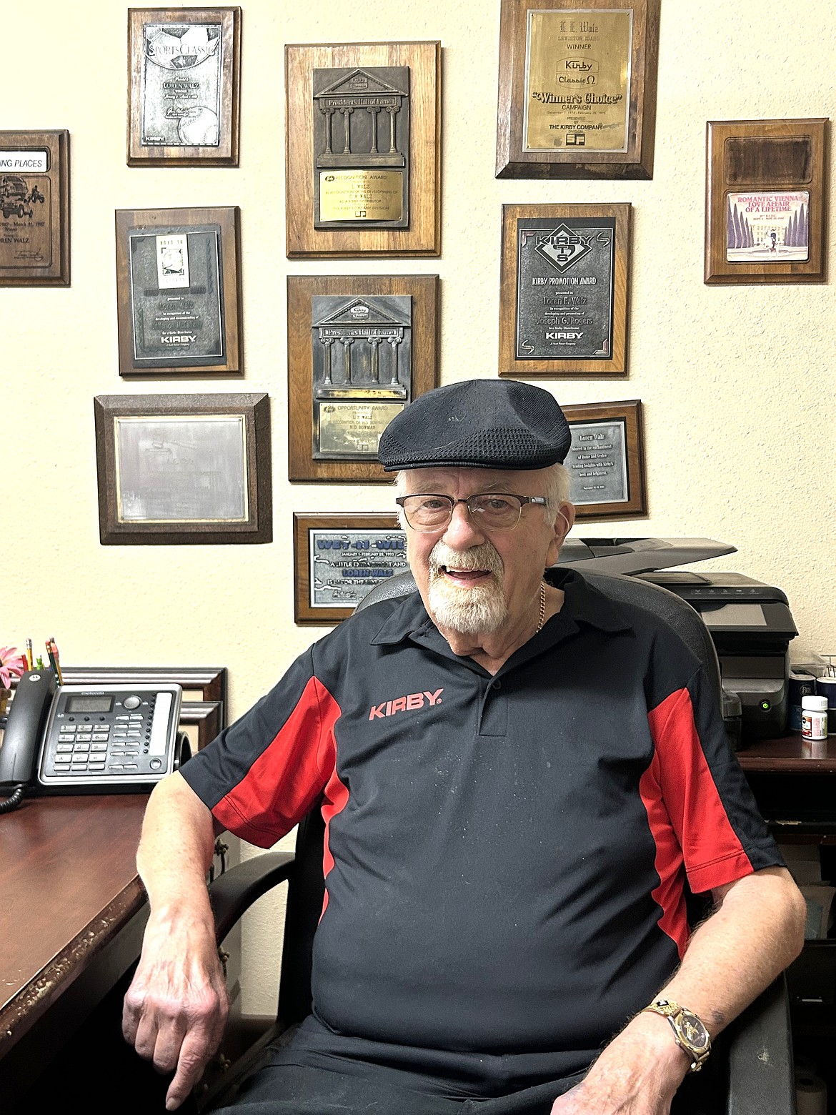 Loren Walz sits in his office, decorated with awards marking his Kirby career.