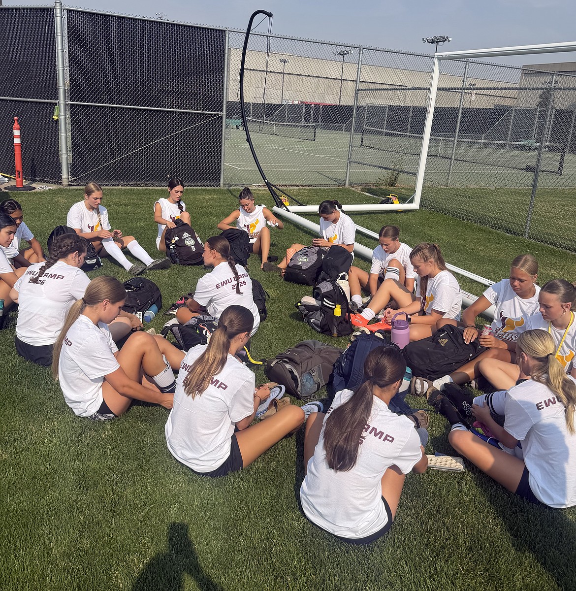 The Moses Lake Mavs’ girls soccer players hang out between drills at the EWU soccer camp.