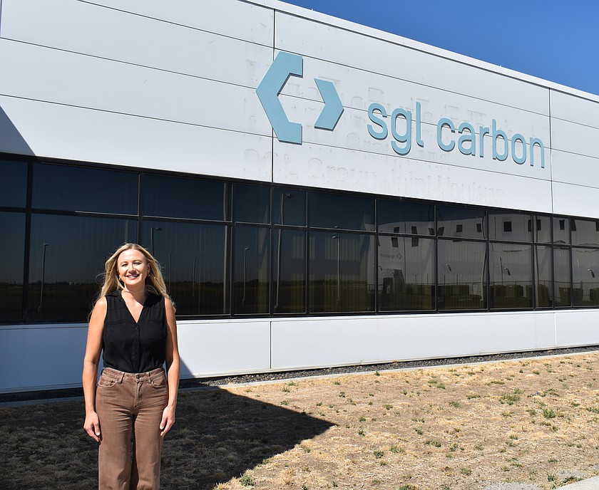 Basin Ag Sales Broker Anna Van Diest stands in front of the shuttered SGL Carbon plant in Moses Lake. Proposals to purchase the plant close on Friday.