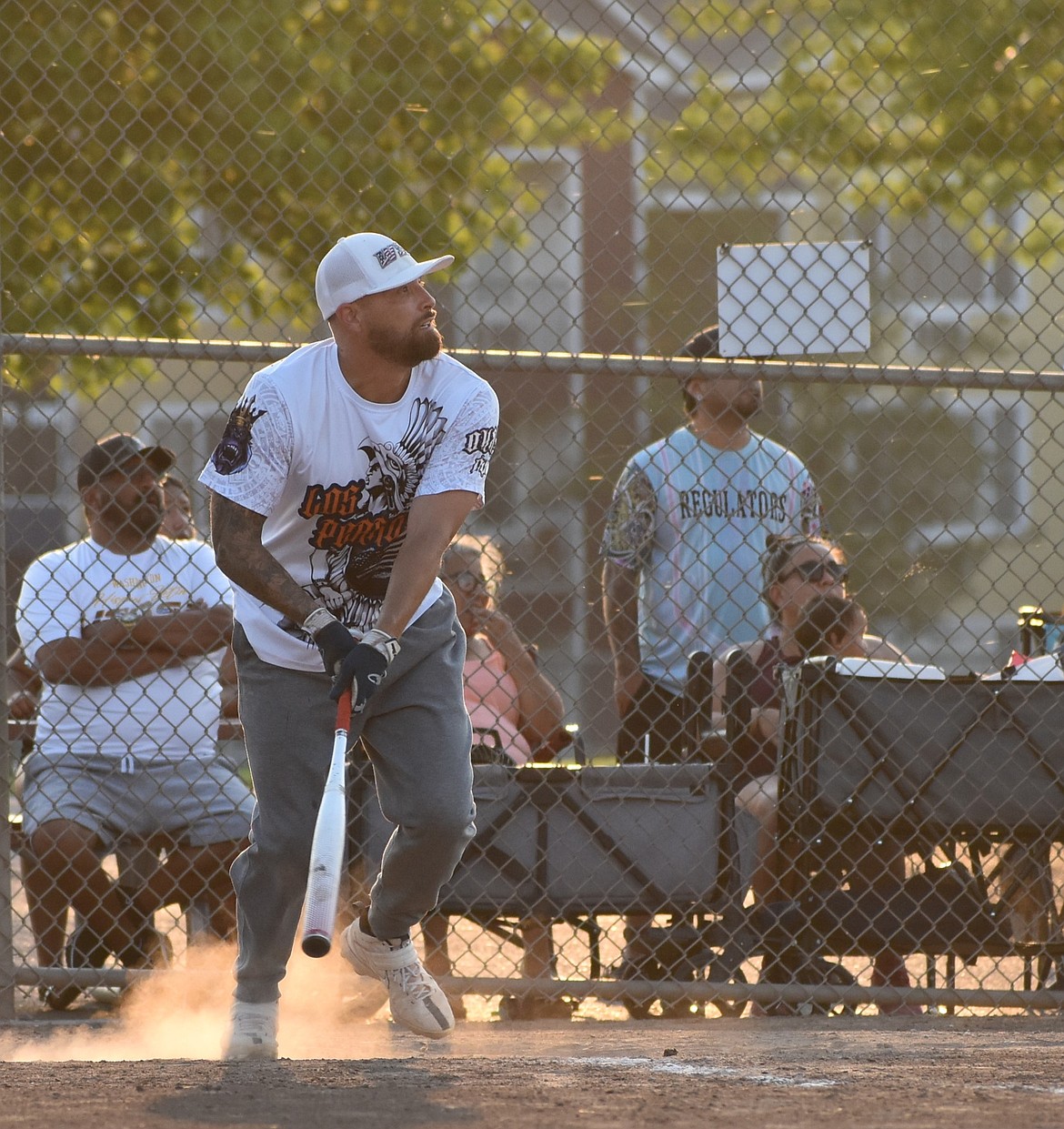 One of the players from the Dawgs gets ready to make a run for first base after connecting for a hit during the Men’s summer softball play in game before the upper division championships.
