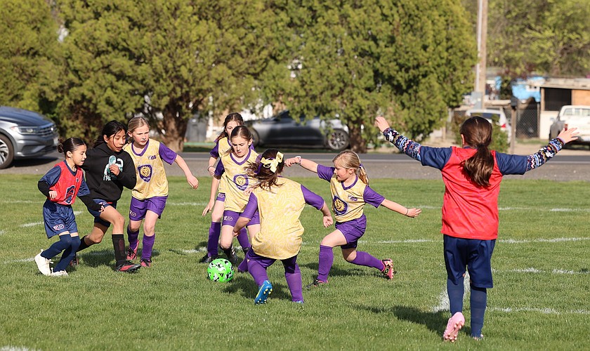 Two of Othello’s youth girls teams battle it out on the field during a game in a previous season.