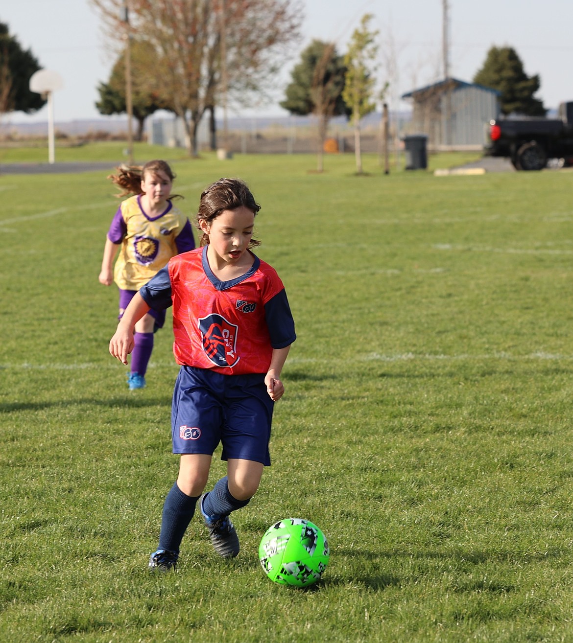 A girl from an Othello soccer team leads the charge as she pushes toward the goal with the city’s youth soccer league.