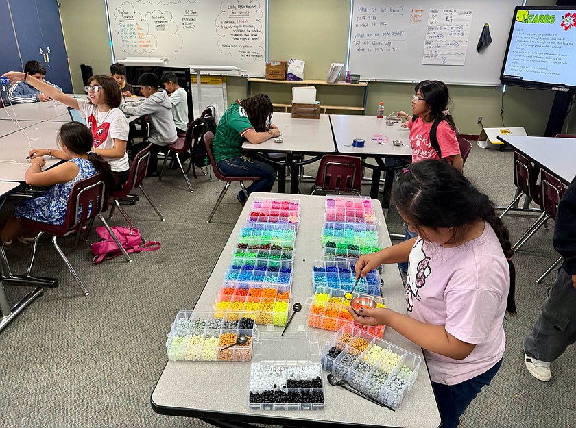 Wahluke DiscoverWorks program students choose from a colorful array of beads for their bead stringing project.