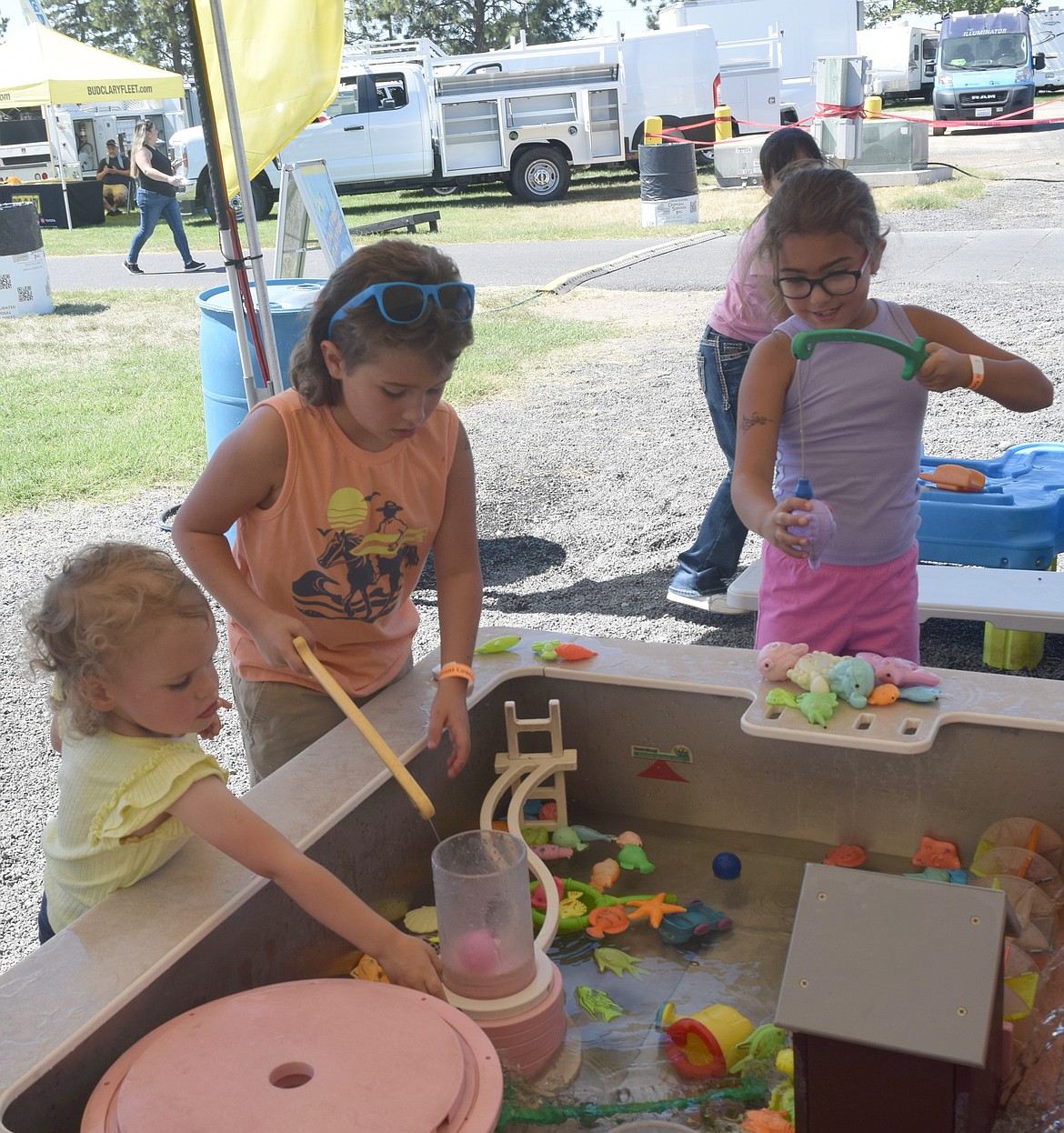 Children play with water toys at the Grant County Fair last year. This year’s fair has lots of offerings for the little ones, including mutton bustin’ and a petting zoo.