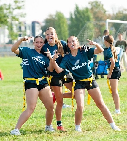 Three girls pose for a photo while representing the Eagles during last year’s Moses Lake Grid Kids flag football season.