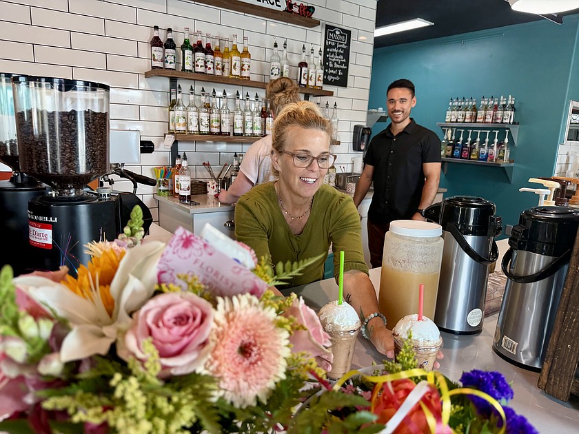 Mason’s Place opened its new location Monday at 101 E. Broadway Ave. after spending 11 years in the Smith Martin Building. Owner Heather Mason hands a couple of customers their blended drinks.
