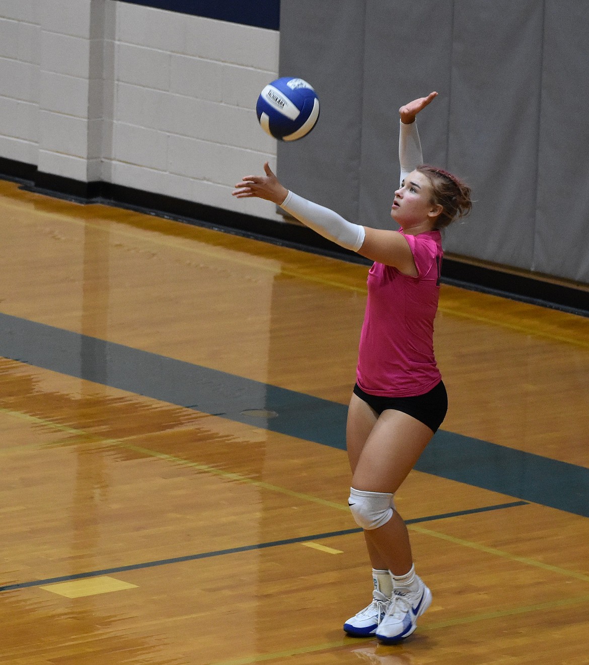 During pink night at Soap Lake for her senior season, Liana Sushik serves the ball to her opponent.