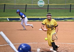 Paige Richardson (in yellow) throws her next pitch in a game during her freshman season at Walla Walla Community College. As a freshman, Richardson saw a lot of playing time which challenged her mentally as a player.