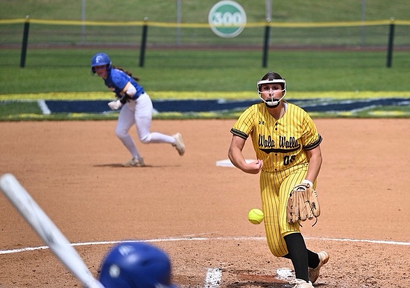 Paige Richardson (in yellow) throws her next pitch in a game during her freshman season at Walla Walla Community College. As a freshman, Richardson saw a lot of playing time which challenged her mentally as a player.