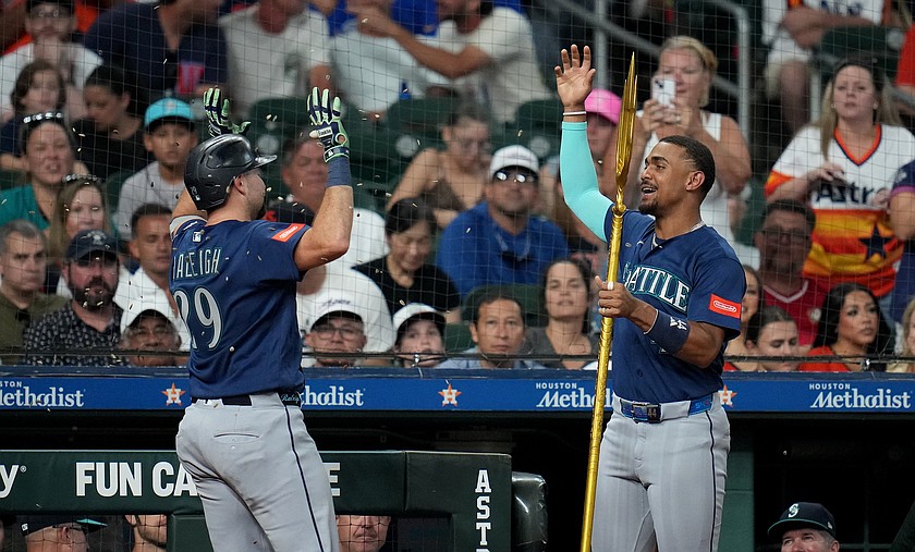 Seattle Mariners' Julio Rodriguez, right, sprinkles Cal Raleigh, left, with sunflower seeds after Raleigh's solo home run during the sixth inning of a baseball game against the Houston Astros, Sunday, Aug. 16, 2026, in Houston. (AP Photo/Karen Warren)