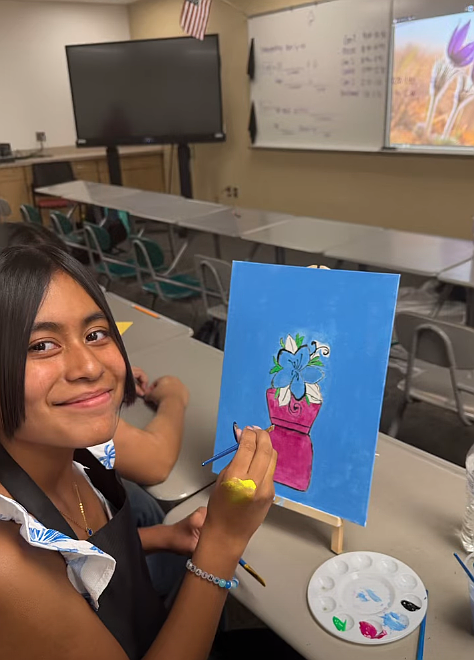 A Royal summer school student shows off her artwork.