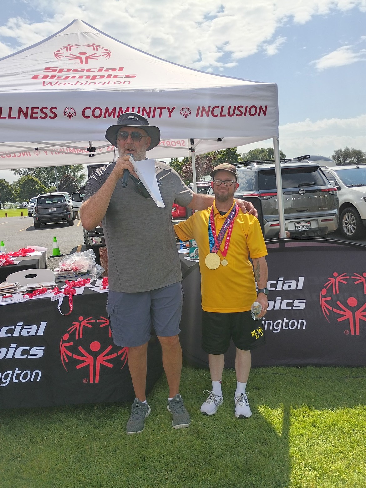 Scorpions bocce player Kirk Wells, right, stands proud wearing his gold medal from the USA games while also receiving a gold for the regionals.