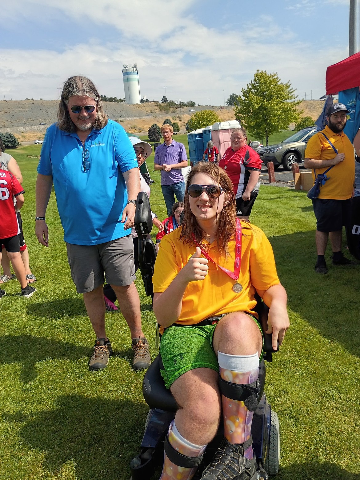 Nate Henninger from the Scorpions bocce team gives a thumbs up and proudly wears his silver medal earned at the regional competition