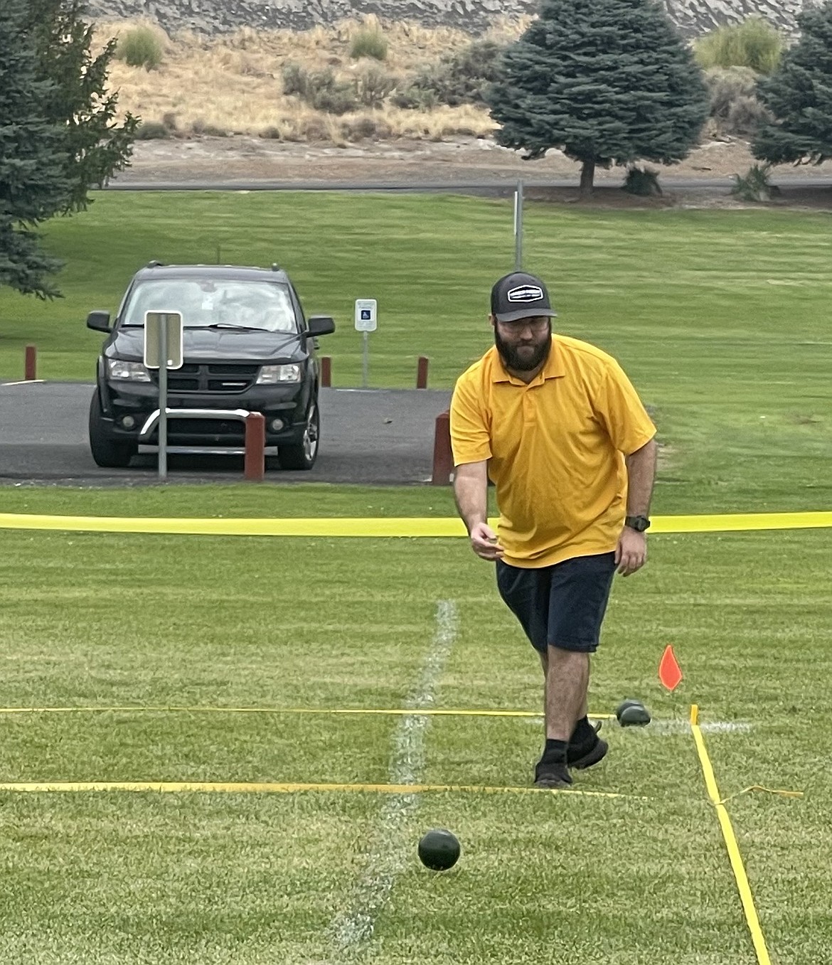 Isaac Lunderville from the Scorpions watches the ball he tossed roll across the grass during a bocce game Saturday. Lunderville claimed a bronze medal at regionals.