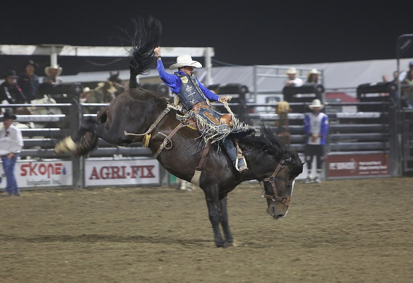 Statler Wright keeps a firm grasp on his rope while performing in the Saddle Bronc competition at the Moses Lake Roundup