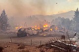 Firefighters make progress against a Nevada wildfire that's destroyed more than 30 homes