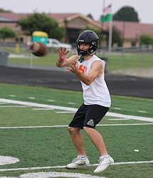 A player from the Knights prepares to make a catch during an early season summer practice. The Knights are hosting this year’s jamboree to kick off the football season.