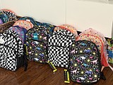Moms Helping Moms organizing backpack giveaway, clothing swap ahead of school year