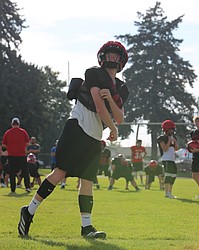 The Broncos’ Shane Kubik airs out a pass during a team drill. Kubik is expected to return as the teams starting quarterback this season.