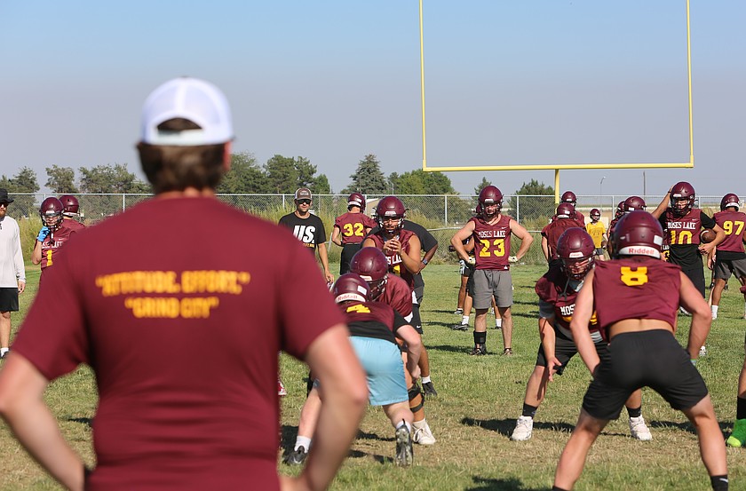 Moses Lake Mavericks Head Coach Kyler Haneberg (up close) watches over his team as they run drills at practice. This will be Haneberg's first year as the head coach for the Mavs.