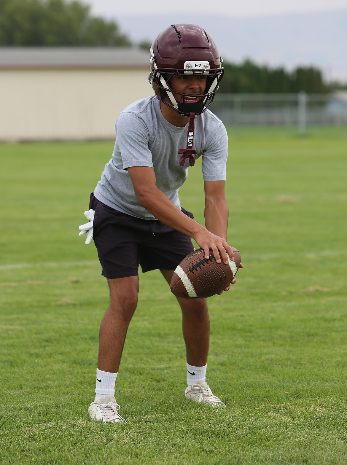 Alejandro Cruz gets some reps in at quarterback before the start of practice for the Wahluke Warriors.