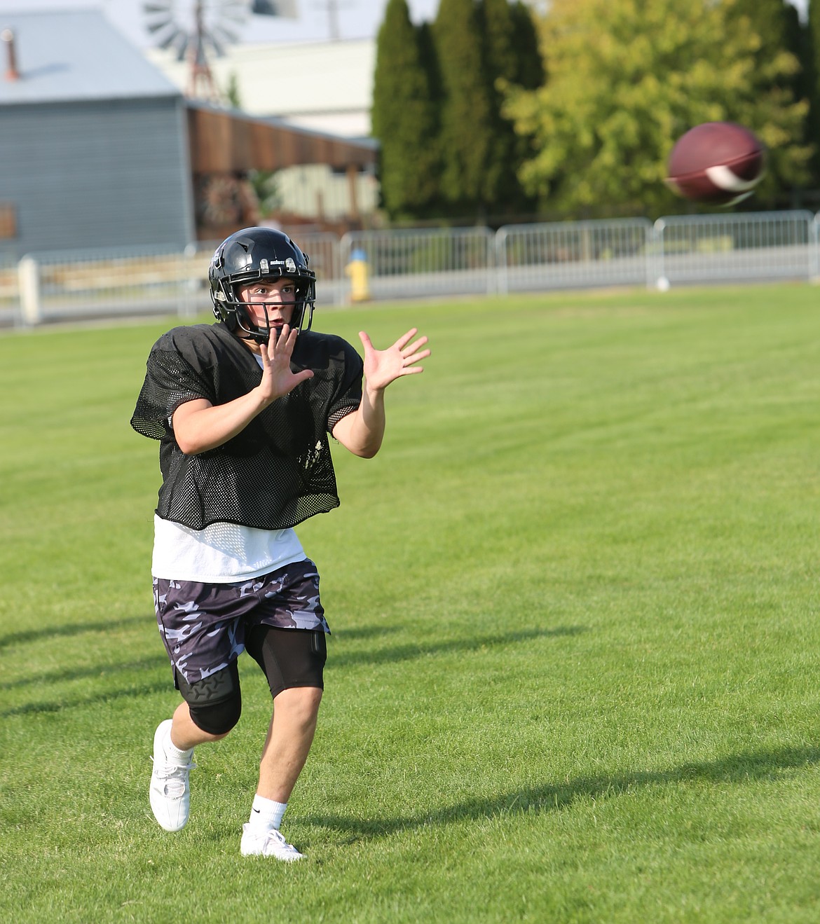 The Warriors’ Ryan Hernandez eyes the ball as he reaches out to make the catch.