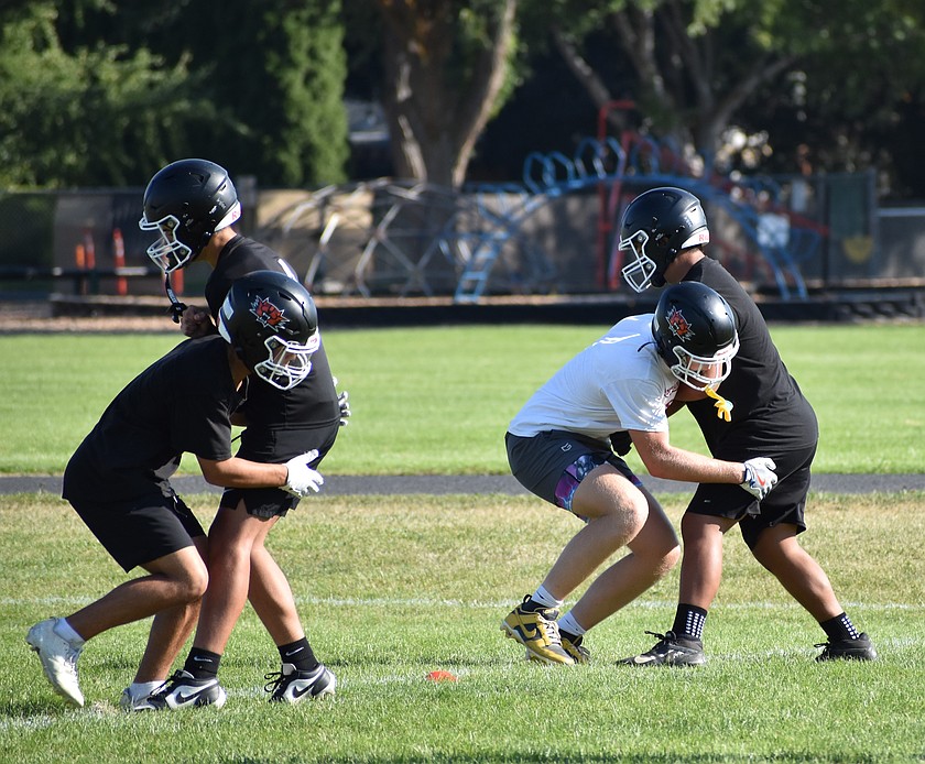 Tigers players work on tackling during an early season afternoon practice this summer.
