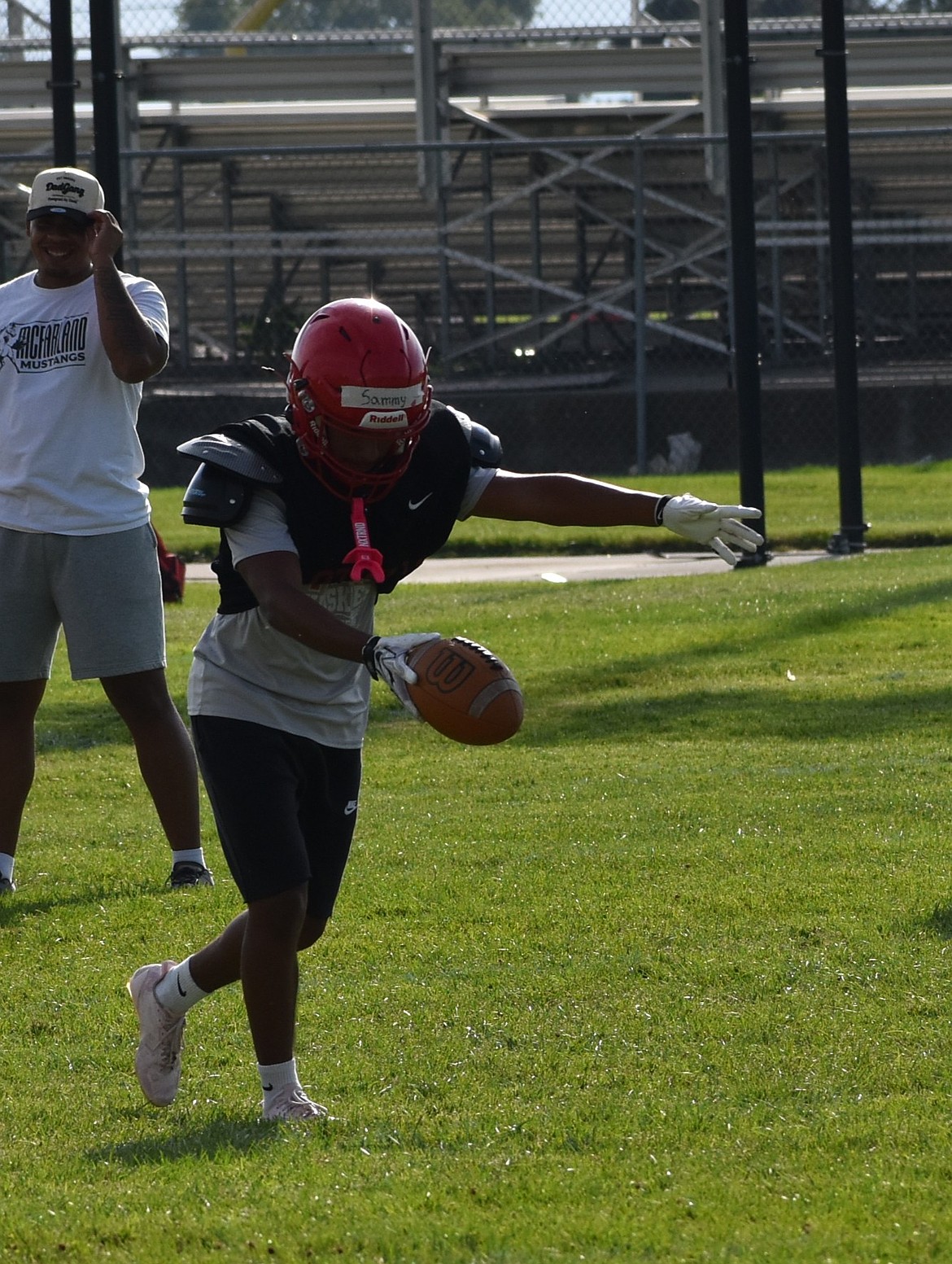 Huskies player Sammy Marroquin prepares to punt the ball in a special teams drill at practice this summer.