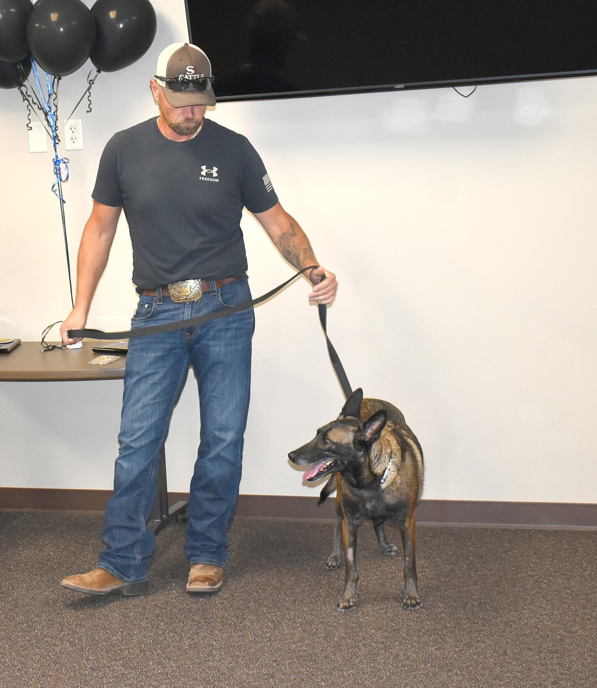 Quincy K-9 Sara (right) also retired Thursday night due to medical issues. She’ll spend her remaining years with her handler, Ofc. Mike Stump (left).