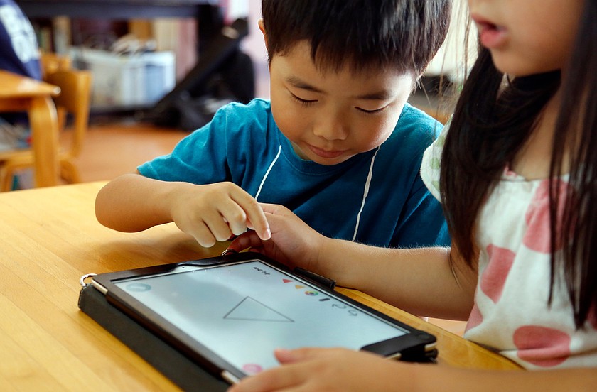 Children work on a digital program at Coby Preschool in Yoshikawa, suburban Tokyo, July 12, 2018.