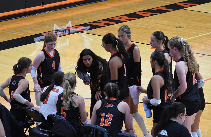 Tigers Head Coach McKaidan Boyd talks with her players during a timeout in the season opener Tuesday evening.