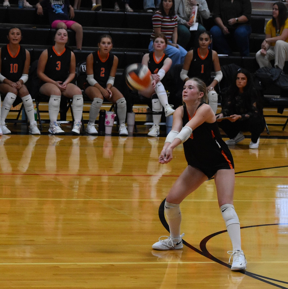 EHS sophomore Sidney Chornuk responds to a hit from Omak Tuesday evening in the first game of the season.