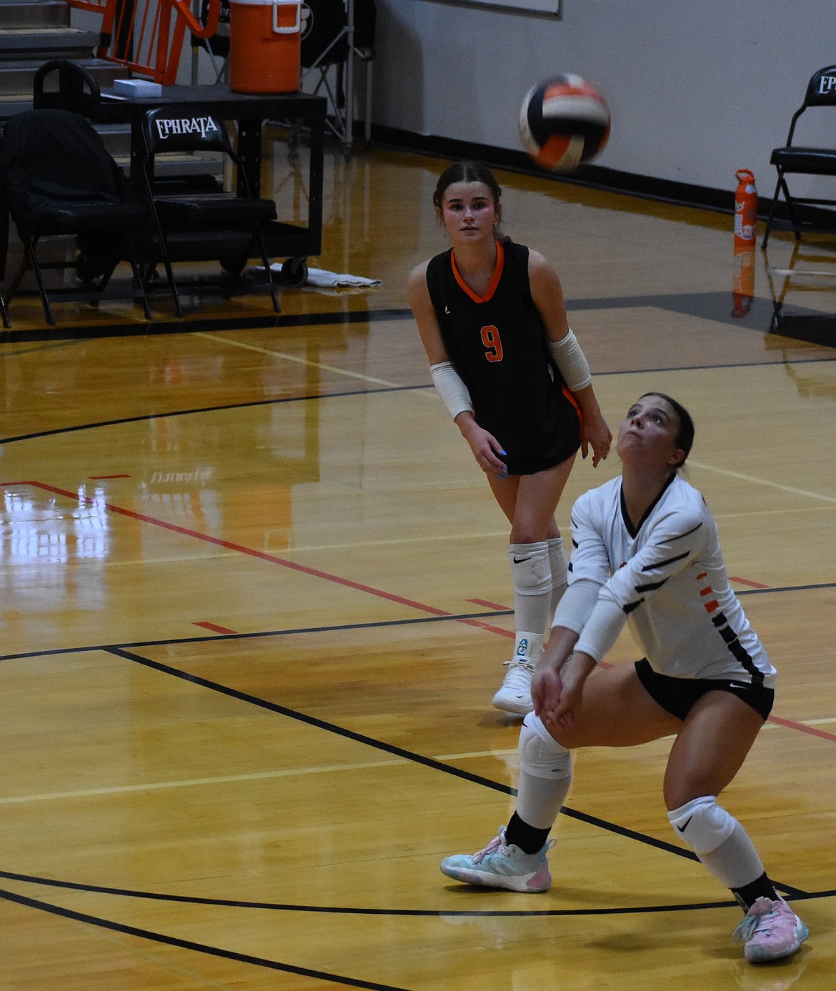 Staci Guerrero (8), a sophomore from the Tigers, keeps her eye on the ball as she looks to bump it up in the air with her teammate Scarlet Wolther (9) watching the play.