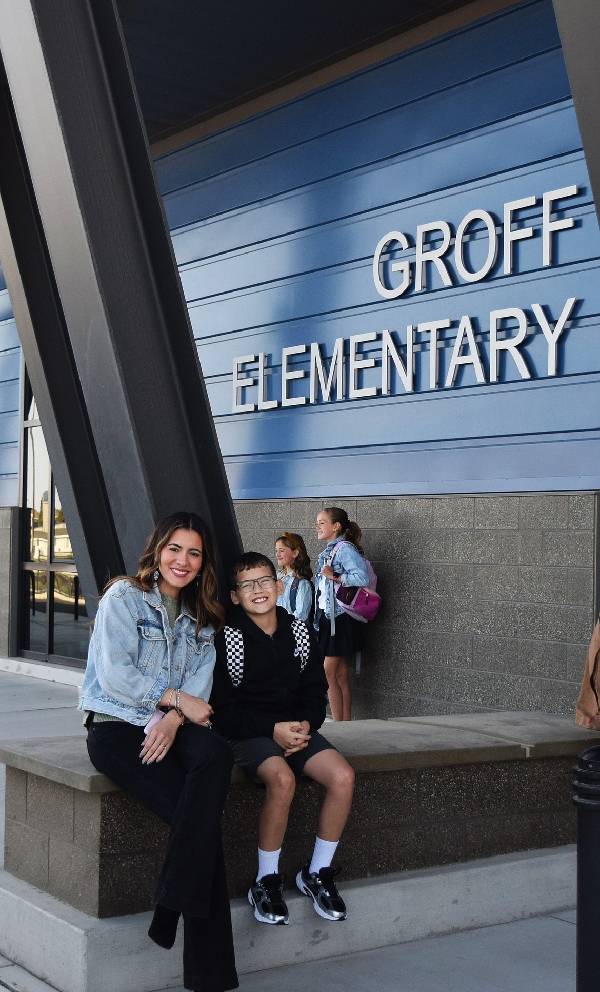 Fifth grader Damian Pruneda and his mom Sonya Pruneda wait for the doors to open on the first day back at Groff Elementary school Wednesday.