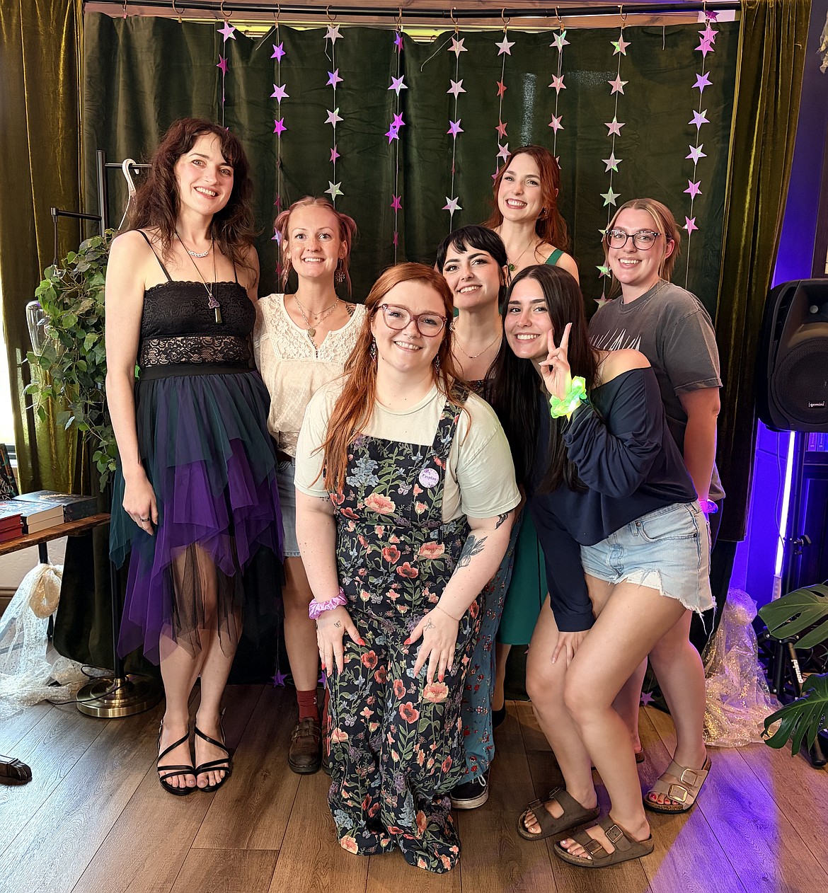 Tyann Bjorkman, Becca Rhoades, and their team members Aliah, Emily, and Ashlee, along with author duo Elizabeth and Helen at a book signing event.