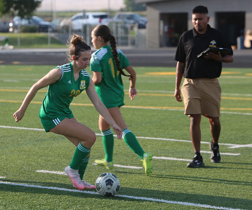 The Jacks’ Brielle Baughman (20) works through a ball drill as new Head Coach Javier Diaz (in black shirt) watches on.